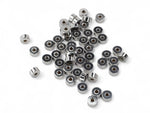 Silver stainless steel disc heishi washer spacer beads on white surface