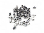 Diamond pattern barrel shaped silver stainless steel beads on a white background.