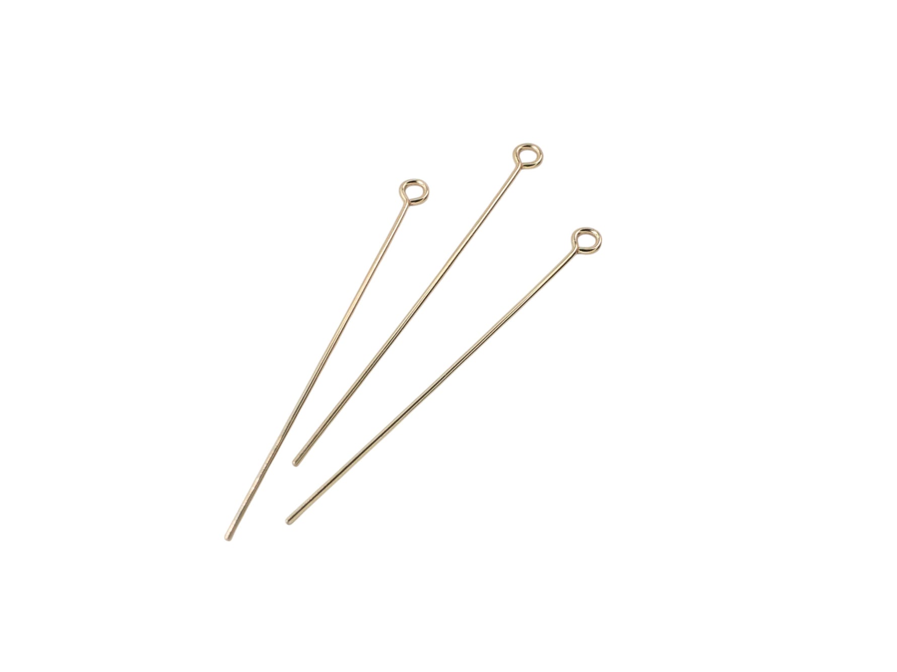 Three gold filled eye pins on a white background