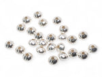 Saucer stainless steel spacer beads on a white background
