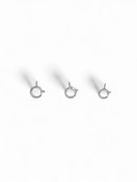 Three silver jewelry clasps on a white background