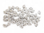Tibetan Silver Sunburst Coin Spacer Beads in medallion shape on a white surface