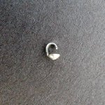 Small sterling silver bead cap on a dark gray background