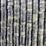 Close-up of multiple vertical strands of polished rectangular beads in a green and black stone with natural green marbling.